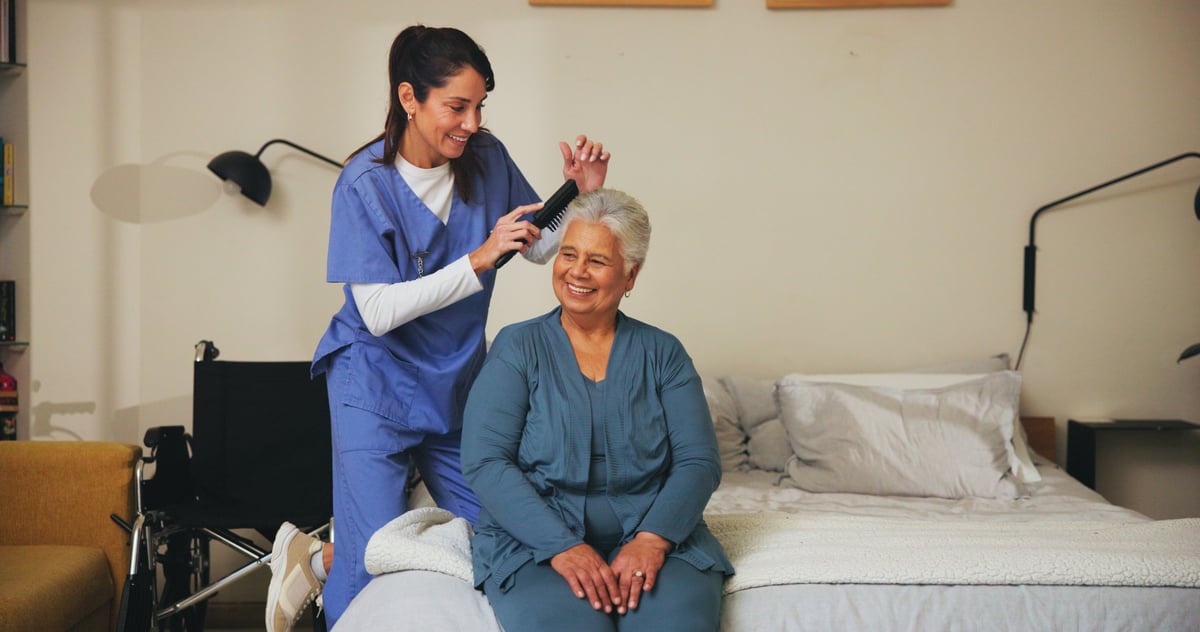 Caregiver helping senior with grooming and daily routine